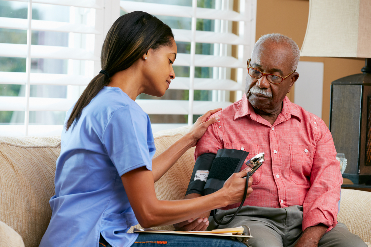 nurse giving companionship care to elderly patient